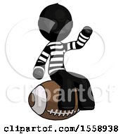 Black Thief Man Sitting On Giant Football