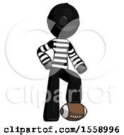 Black Thief Man Standing With Foot On Football