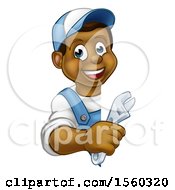 Clipart Of A Cartoon Happy Black Male Plumber Holding An Adjustable Wrench Around A Sign Royalty Free Vector Illustration