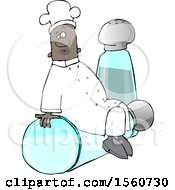 Black Male Chef Sitting On Top Of A Tipped Salt Shaker In Front Of A Pepper Shaker