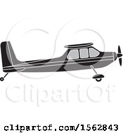 Clipart Of A Silhouetted Airplane With A Propeller Royalty Free Vector Illustration by Lal Perera