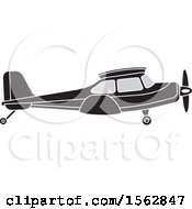 Clipart Of A Silhouetted Airplane With A Propeller Royalty Free Vector Illustration