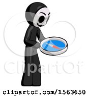 Black Little Anarchist Hacker Man Looking At Large Compass Facing Right