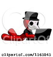 Red Plague Doctor Man Using Laptop Computer While Lying On Floor Side Angled View