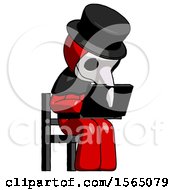 Poster, Art Print Of Red Plague Doctor Man Using Laptop Computer While Sitting In Chair Angled Right