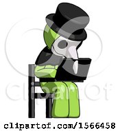 Green Plague Doctor Man Using Laptop Computer While Sitting In Chair Angled Right