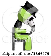 Green Plague Doctor Man Using Laptop Computer While Sitting In Chair View From Side