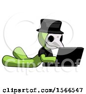 Poster, Art Print Of Green Plague Doctor Man Using Laptop Computer While Lying On Floor Side Angled View