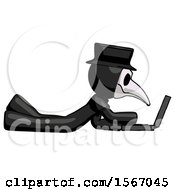 Black Plague Doctor Man Using Laptop Computer While Lying On Floor Side View