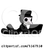 Black Plague Doctor Man Using Laptop Computer While Lying On Floor Side Angled View
