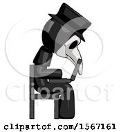 Black Plague Doctor Man Using Laptop Computer While Sitting In Chair View From Side