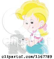 Blond Caucasian Girl Kneeling And Playing With Her Pet Bunny Rabbit