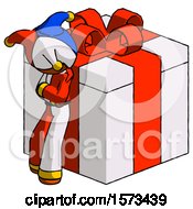Orange Jester Joker Man Leaning On Gift With Red Bow Angle View