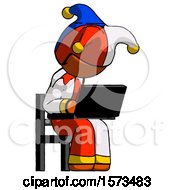 Poster, Art Print Of Orange Jester Joker Man Using Laptop Computer While Sitting In Chair Angled Right