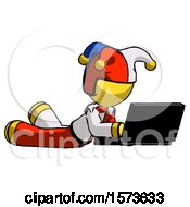 Poster, Art Print Of Yellow Jester Joker Man Using Laptop Computer While Lying On Floor Side Angled View
