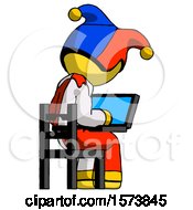 Poster, Art Print Of Yellow Jester Joker Man Using Laptop Computer While Sitting In Chair View From Back