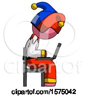 Pink Jester Joker Man Using Laptop Computer While Sitting In Chair View From Side