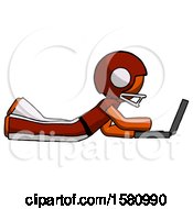 Orange Football Player Man Using Laptop Computer While Lying On Floor Side View