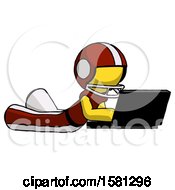 Poster, Art Print Of Yellow Football Player Man Using Laptop Computer While Lying On Floor Side Angled View