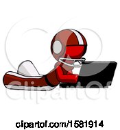 Poster, Art Print Of Red Football Player Man Using Laptop Computer While Lying On Floor Side Angled View