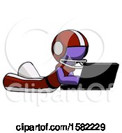 Poster, Art Print Of Purple Football Player Man Using Laptop Computer While Lying On Floor Side Angled View