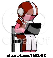 Pink Football Player Man Using Laptop Computer While Sitting In Chair Angled Right