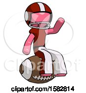 Pink Football Player Man Sitting On Giant Football