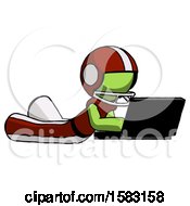 Poster, Art Print Of Green Football Player Man Using Laptop Computer While Lying On Floor Side Angled View