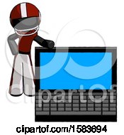 Black Football Player Man Beside Large Laptop Computer Leaning Against It