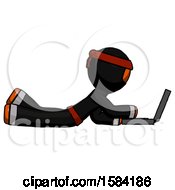 Poster, Art Print Of Orange Ninja Warrior Man Using Laptop Computer While Lying On Floor Side View