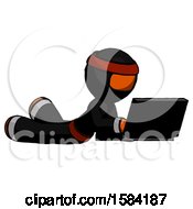Poster, Art Print Of Orange Ninja Warrior Man Using Laptop Computer While Lying On Floor Side Angled View