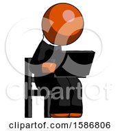 Orange Clergy Man Using Laptop Computer While Sitting In Chair Angled Right