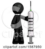 Black Clergy Man Holding Large Syringe