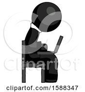 Black Clergy Man Using Laptop Computer While Sitting In Chair View From Side