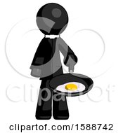 Black Clergy Man Frying Egg In Pan Or Wok