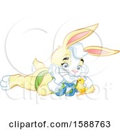 Poster, Art Print Of Yellow Easter Bunny Rabbit Laying On The Ground And Watching A Chick