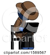 Blue Detective Man Using Laptop Computer While Sitting In Chair Angled Right