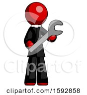Red Clergy Man Holding Large Wrench With Both Hands