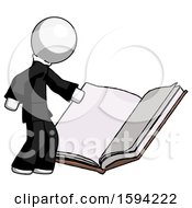 White Clergy Man Reading Big Book While Standing Beside It