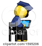 Yellow Police Man Using Laptop Computer While Sitting In Chair View From Back