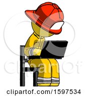 Yellow Firefighter Fireman Man Using Laptop Computer While Sitting In Chair Angled Right