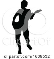Clipart Of A Silhouetted Male Guitarist Royalty Free Vector Illustration by AtStockIllustration