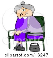 Old Lady With Gray Hair Wearing A Purple Dress And Sitting In A Chair With Her Purse On The Ground