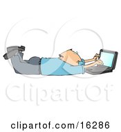 Balding Caucasian Businessman In A Blue Shirt And Slacks Lying On His Stomach While Typing On A Laptop Computer That Is Set On Wireless Internet
