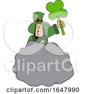 Cartoon St Patricks Day Leprechaun Holding Up A Shamrock Behind A Boulder