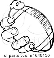 Hand Holding American Football Ball