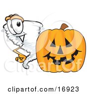 Tornado Mascot Cartoon Character Standing By A Halloween Pumpkin