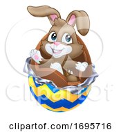 Easter Bunny Rabbit Breaking Out Of Chocolate Egg by AtStockIllustration