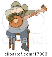 Caucasian Male Cowboy Sitting On A Stool And Playing A Banjo While Entertaining People During An Event