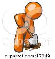 Orange Man Using A Shovel To Dig A Hole For A Plant In A Garden